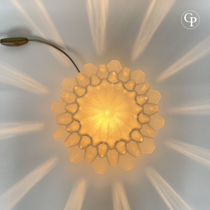 Top-down view of the glowing vintage Art Deco "Skyscraper" table lamp with its geometric stepped frosted glass shade radiating warm light | Vue de dessus de la lampe de table vintage Art Déco "Skyscraper" allumée, avec son abat-jour en verre dépoli à étages géométriques diffusant une lumière chaude