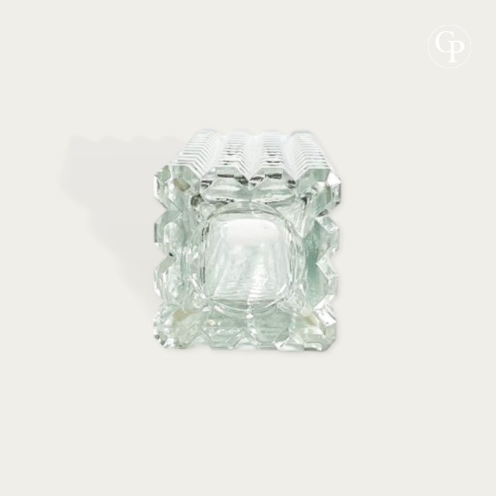 Top down view showing the square opening and thick faceted structure of the clear pressed glass monolith vase by Rudolf Jurnikl for Sklo Union 1963 on a plain background with Galerie Popincourt watermark logo | Vue de dessus montrant l'ouverture carrée et la structure épaisse facettée du vase monolithe en verre pressé transparent par Rudolf Jurnikl pour Sklo Union 1963 sur fond uni avec logo en filigrane Galerie Popincourt