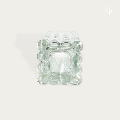 Top down view showing the square opening and thick faceted structure of the clear pressed glass monolith vase by Rudolf Jurnikl for Sklo Union 1963 on a plain background with Galerie Popincourt watermark logo | Vue de dessus montrant l'ouverture carrée et la structure épaisse facettée du vase monolithe en verre pressé transparent par Rudolf Jurnikl pour Sklo Union 1963 sur fond uni avec logo en filigrane Galerie Popincourt